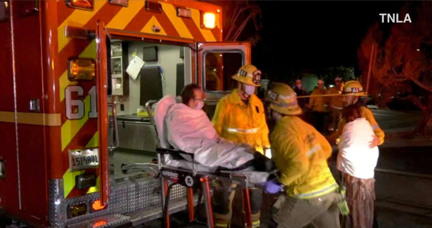 Los servicios de emergencia ayudando a una persona a subir a una ambulancia luego del tiroteo en Monterey Park, California.